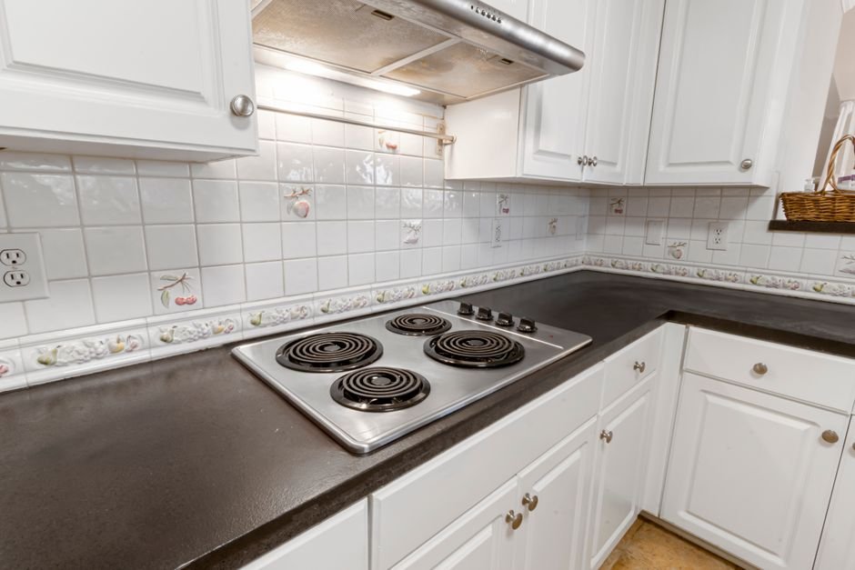 Kitchen backsplash electrical boxes leveled between quartz countertop and upper cabinets